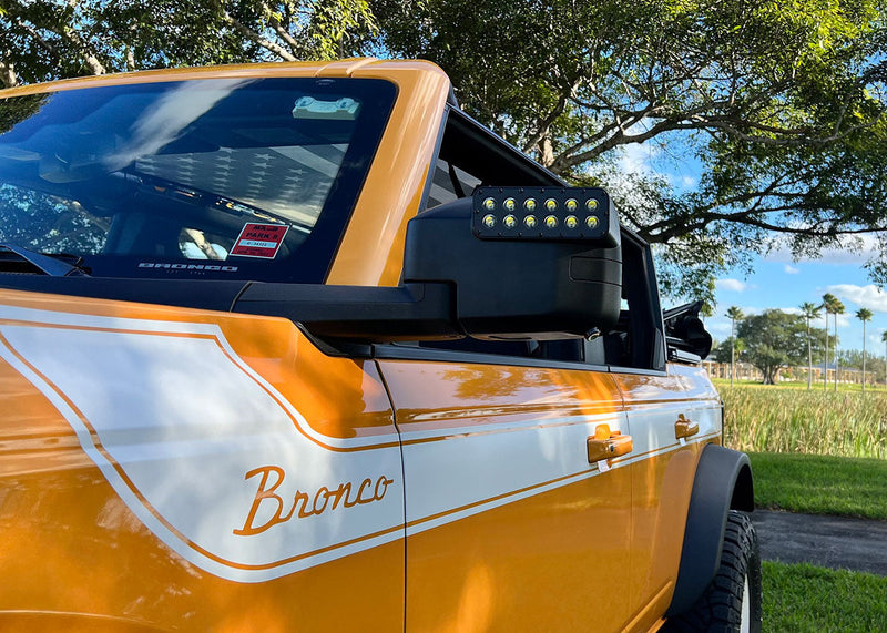 Load image into Gallery viewer, Close-up of bronco LED side mirrors installed on orange bronco

